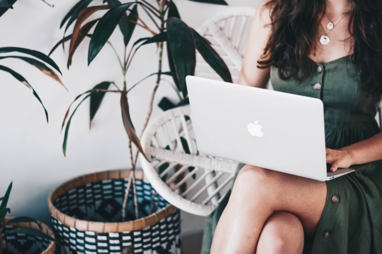 A successful digital nomad works on her laptop