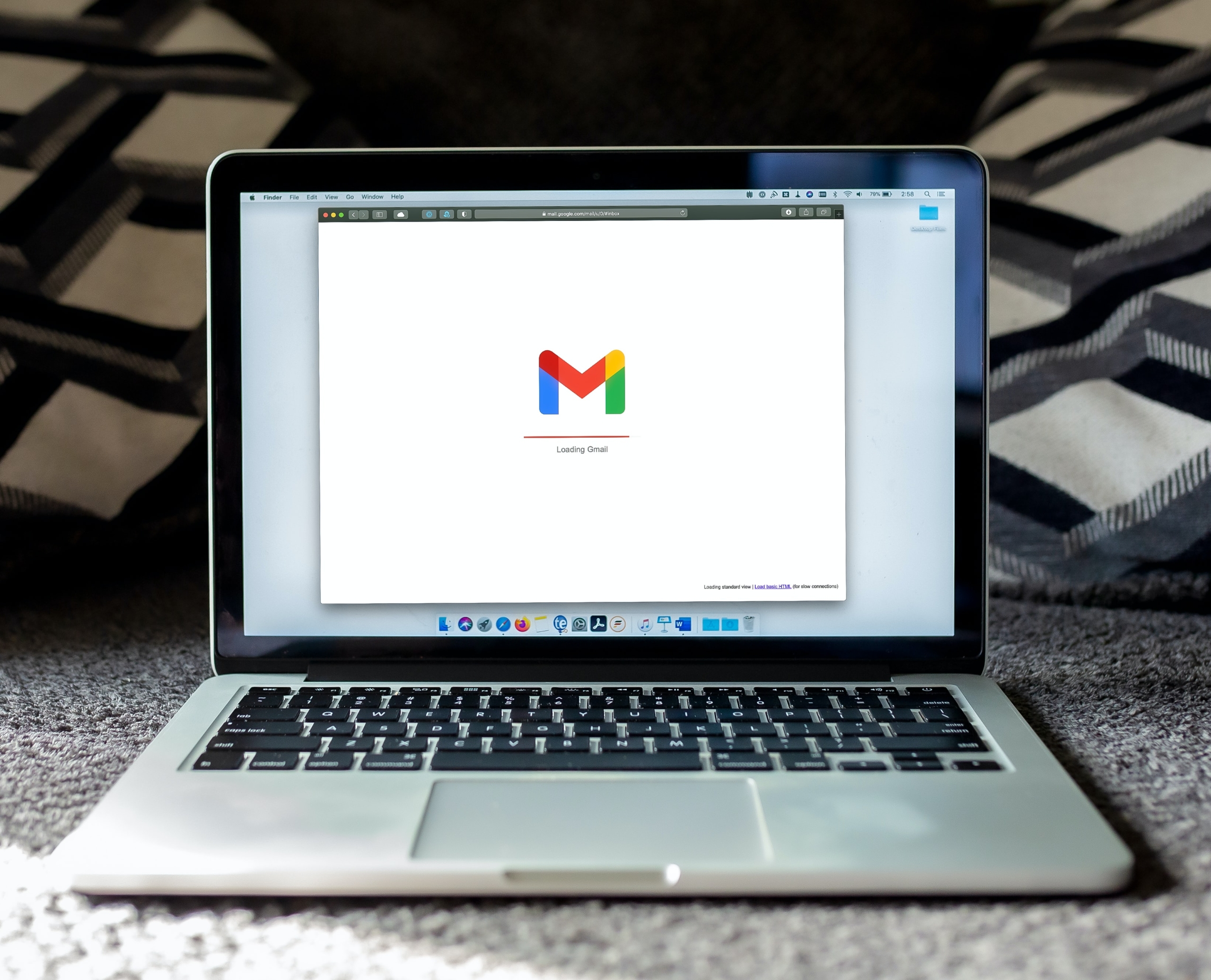 A laptop loads GMail