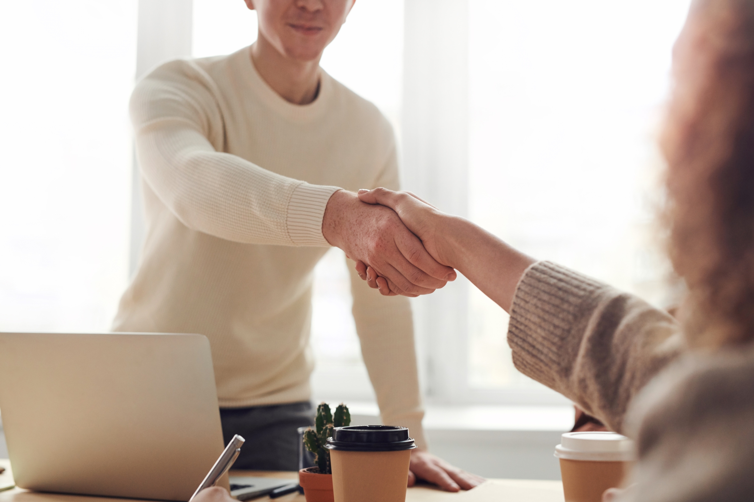 Two office workers shake hands