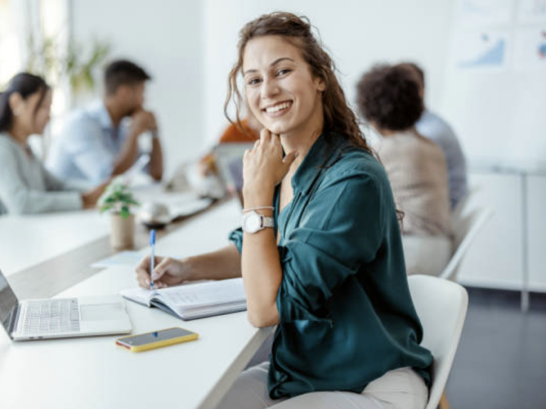 A smiling woman working in an office conference room