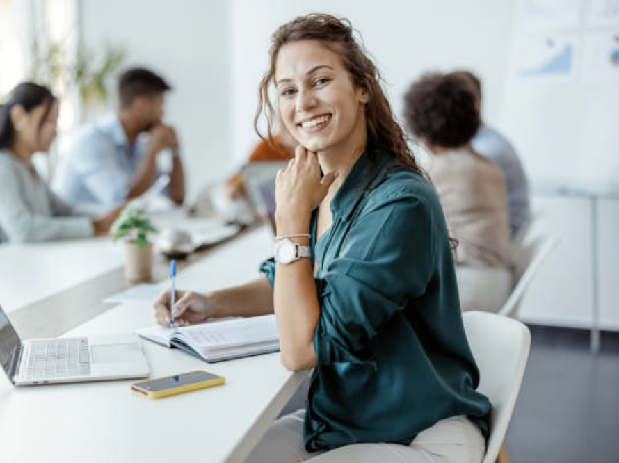 A smiling woman working in an office conference room