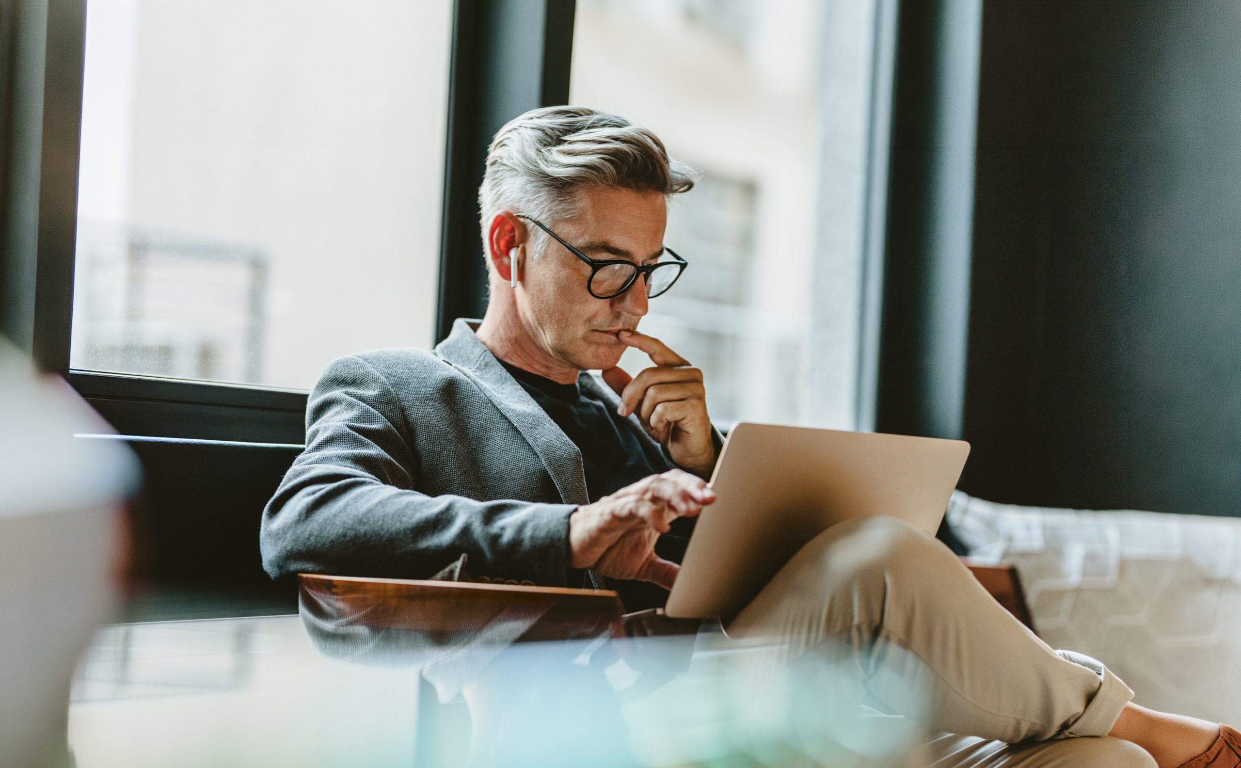 Businessman looking at laptop and thinking.