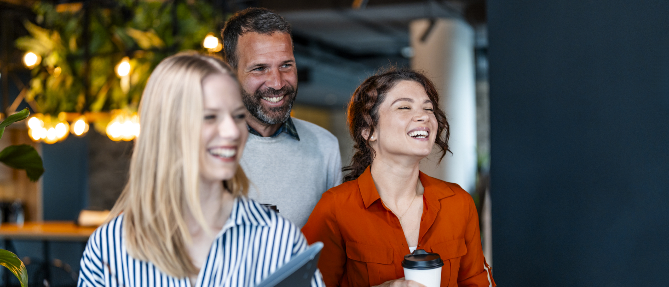 Three colleagues laugh together