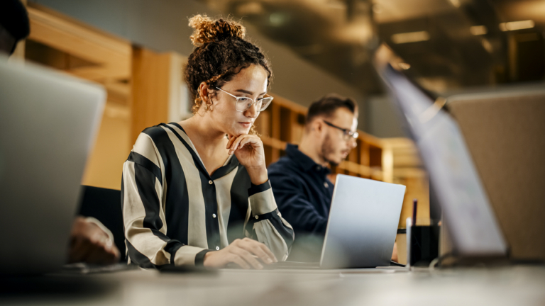 Woman works at laptop in co working space