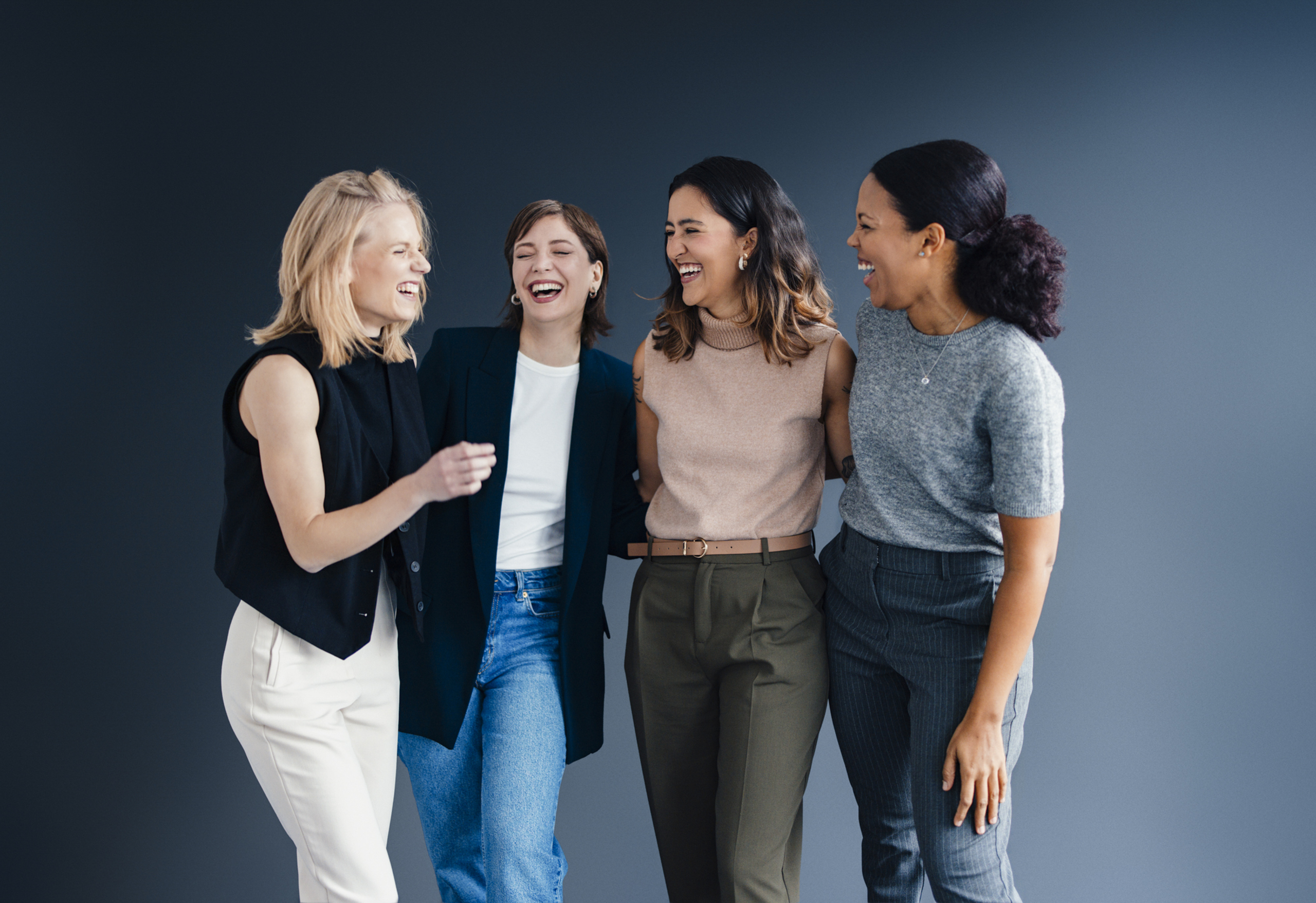 A group of smiling, cheerful business women