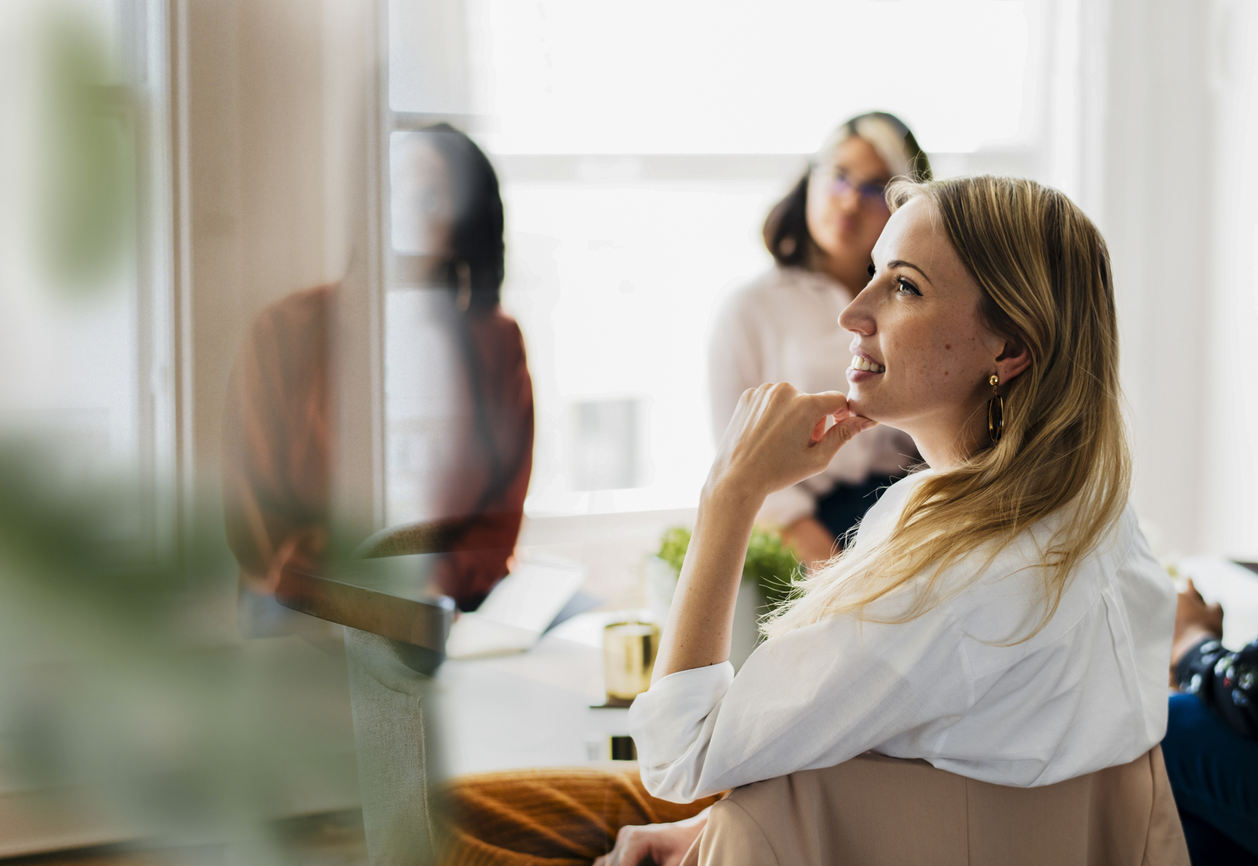 Three business women work together in a meeting