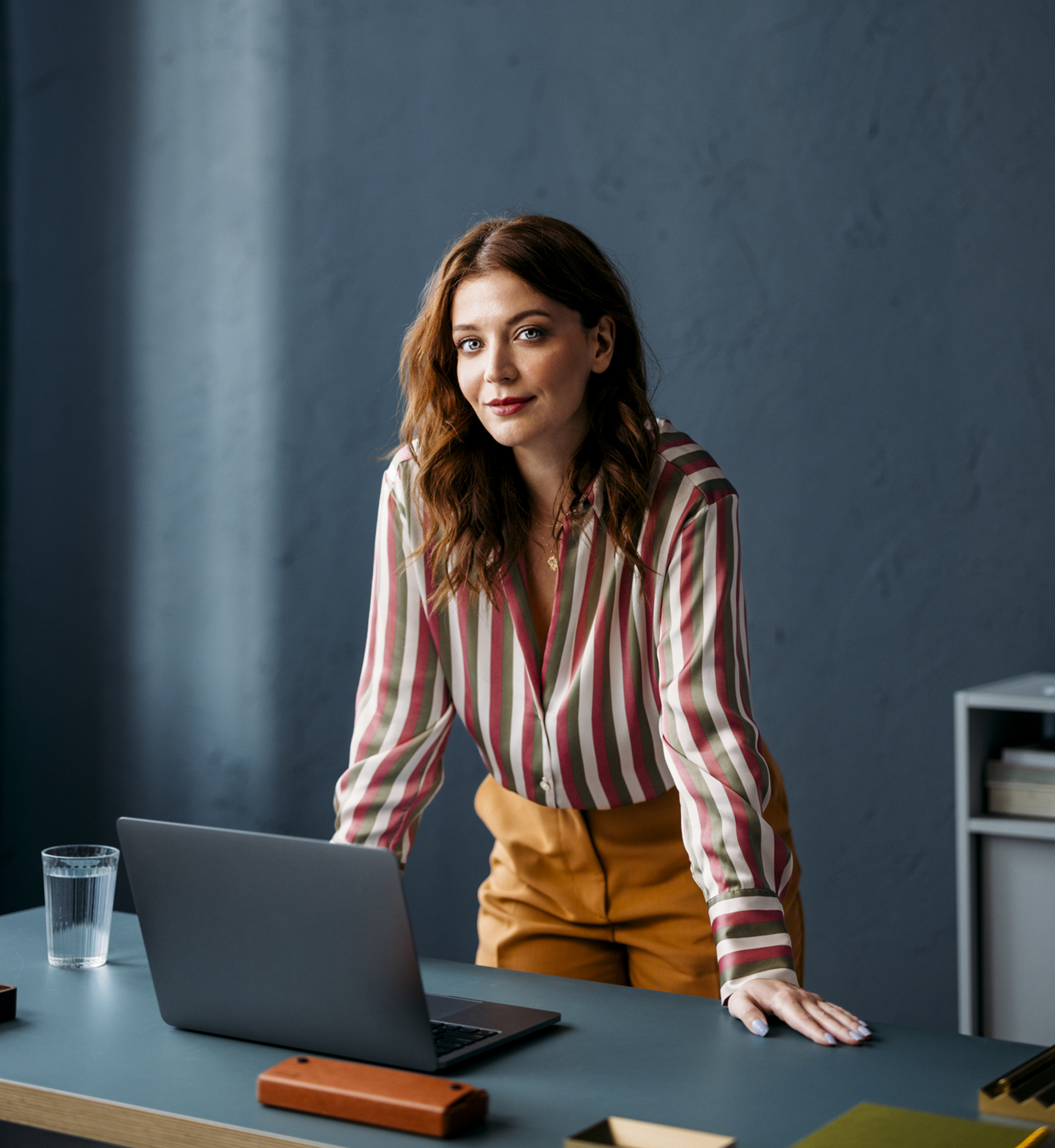 Portrait of a Professional Woman at Work in a modern Office with a Laptop